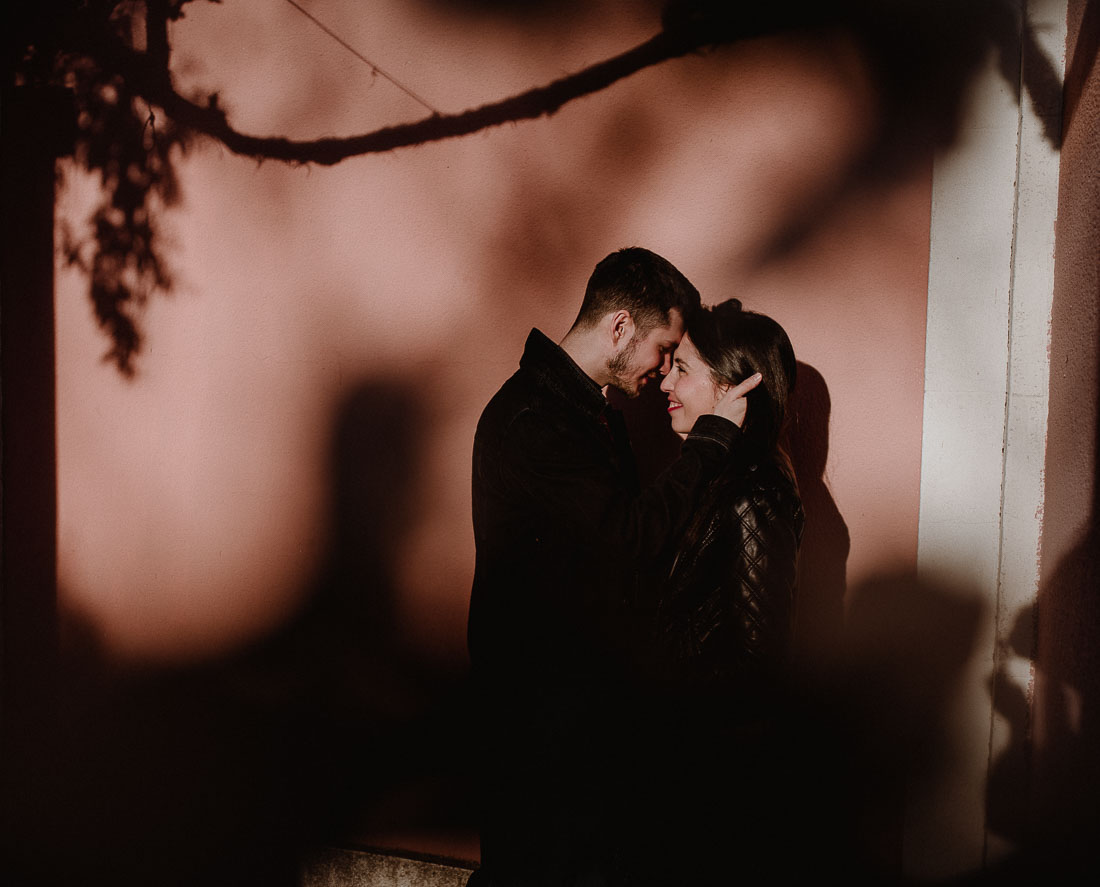 Couple standing in front of wall